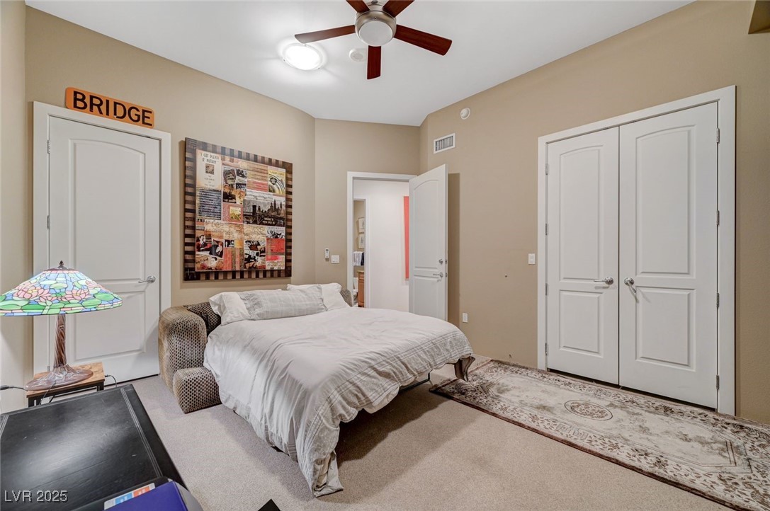 360 East Desert Inn Road, Unit 1404 Las Vegas, NV 89109 - Photo 34 of 52 Bedroom featuring carpet flooring, a ceiling fan, and a closet