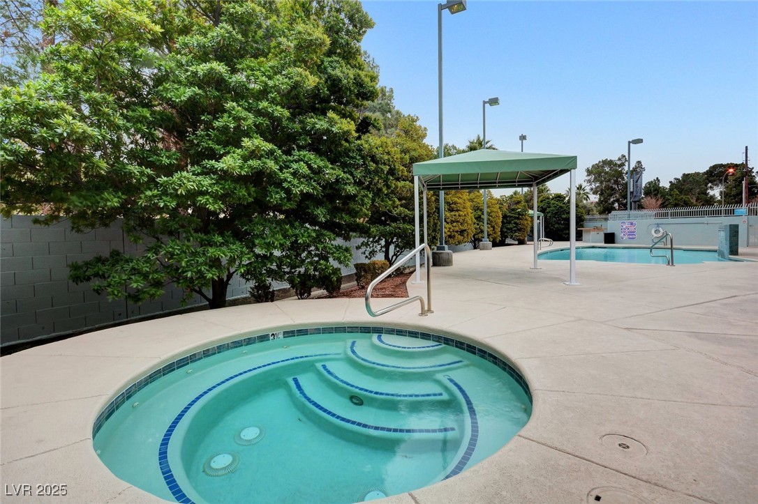 360 East Desert Inn Road, Unit 1404 Las Vegas, NV 89109 - Photo 43 of 52 Community pool featuring a patio and a community hot tub