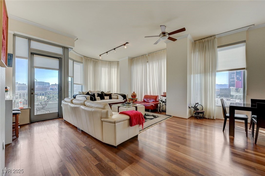 360 East Desert Inn Road, Unit 1404 Las Vegas, NV 89109 - Photo 9 of 52 Living area with hardwood / wood-style flooring, track lighting, a city view, crown molding, and a ceiling fan