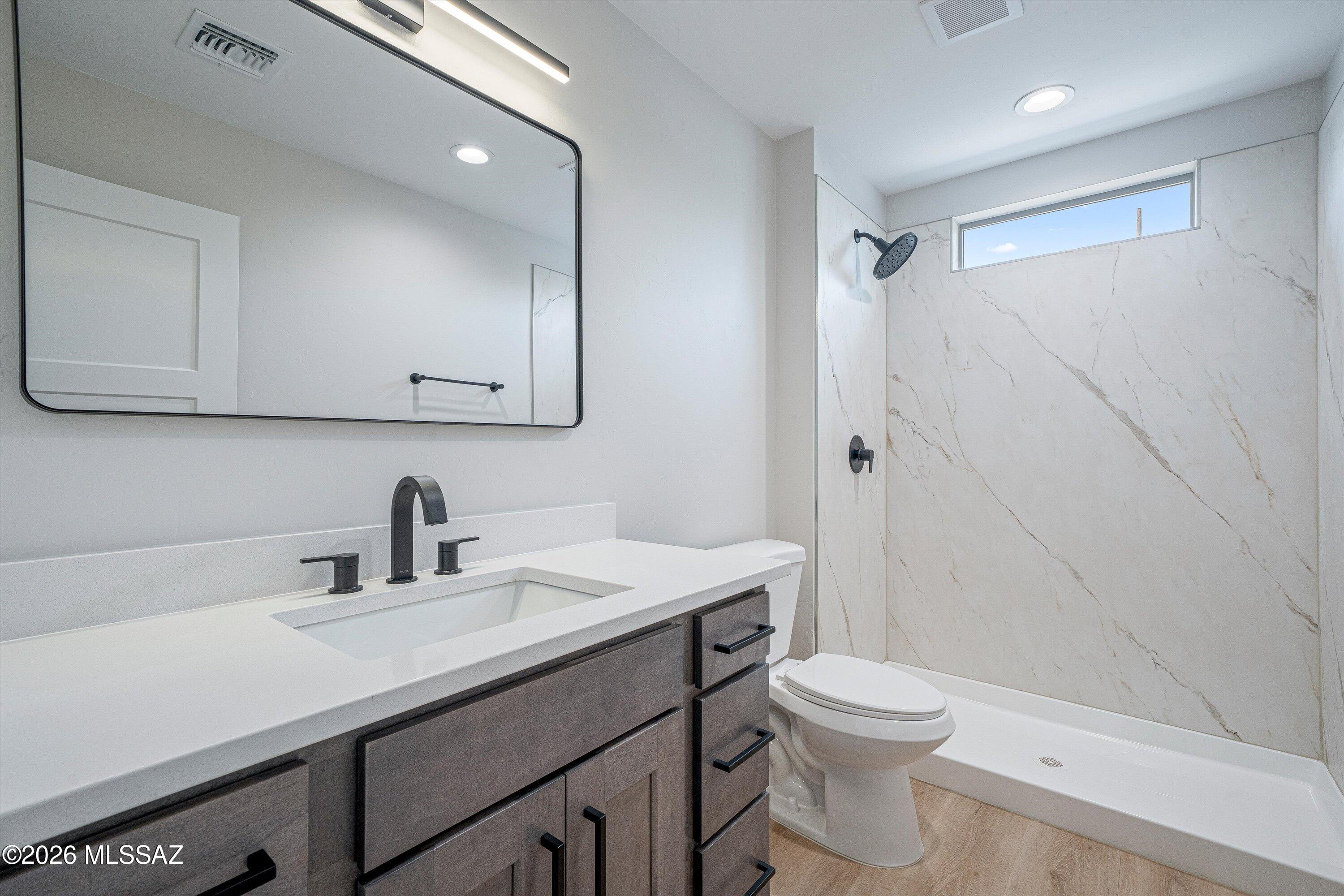 739 North Queen Avenue, Unit 2 Tucson, AZ 85705 - Photo 25 of 28 a bathroom with a sink a toilet and shower