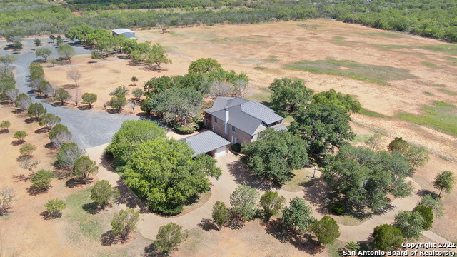 1015 Vaughn Road Pearsall, TX 78061 - Photo 1 of 1 an aerial view of a house with a yard