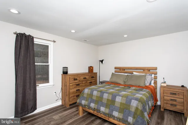 a bedroom with a bed and cabinet