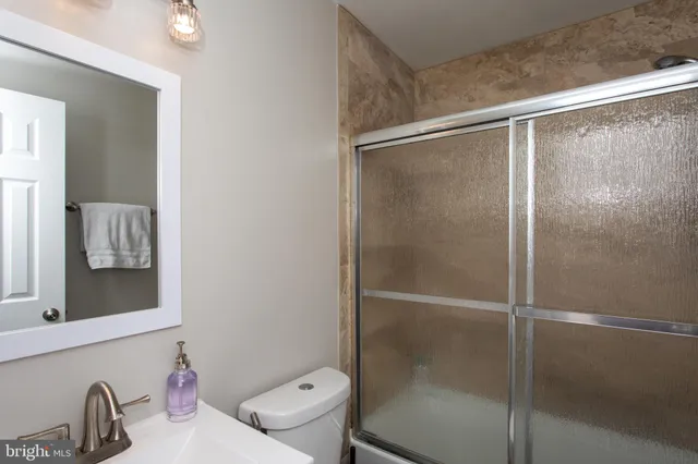 a bathroom with a shower and a sink