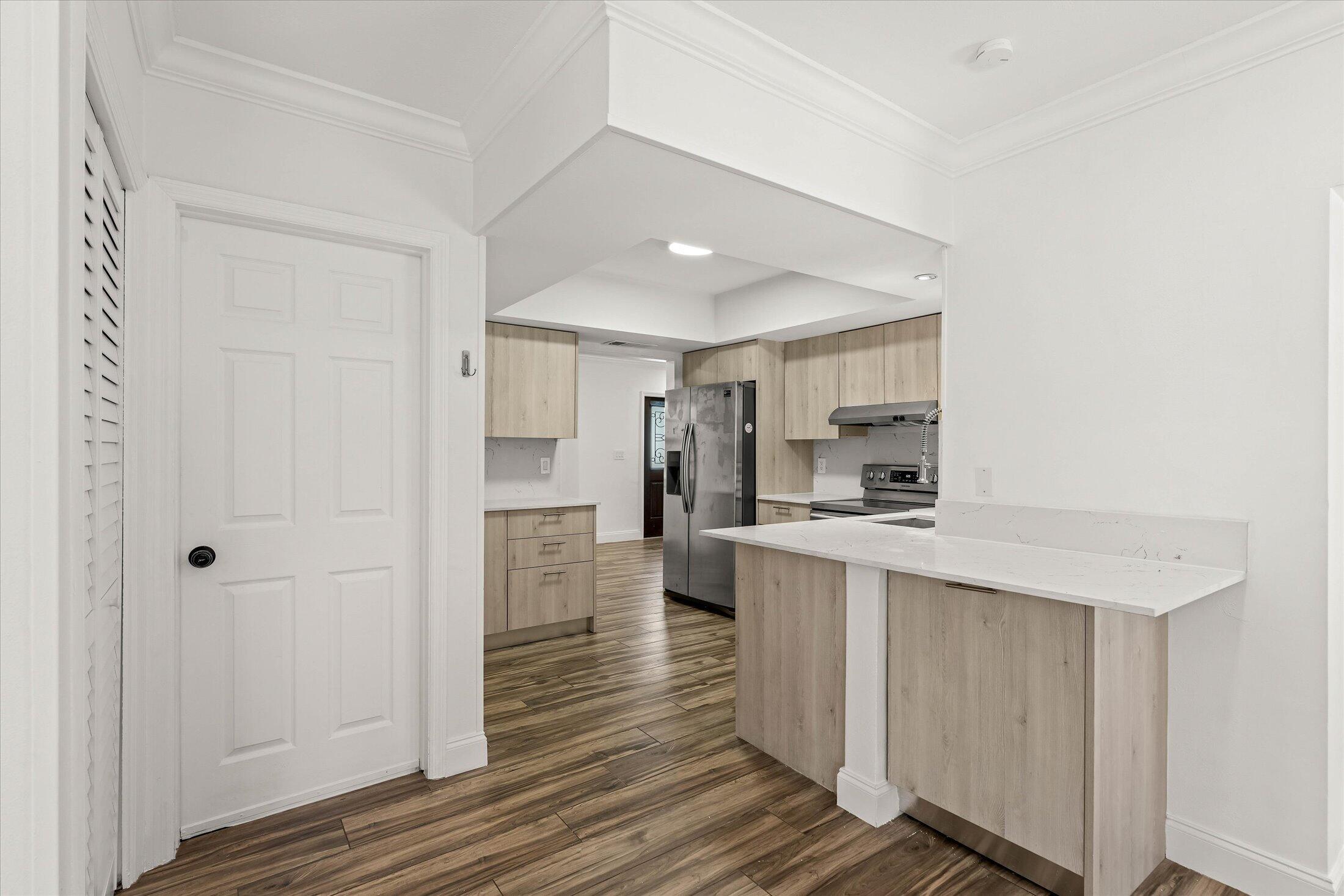884 Northwest 6th Drive Boca Raton, FL 33486 - Photo 11 of 37 Kitchen with Door to Garage