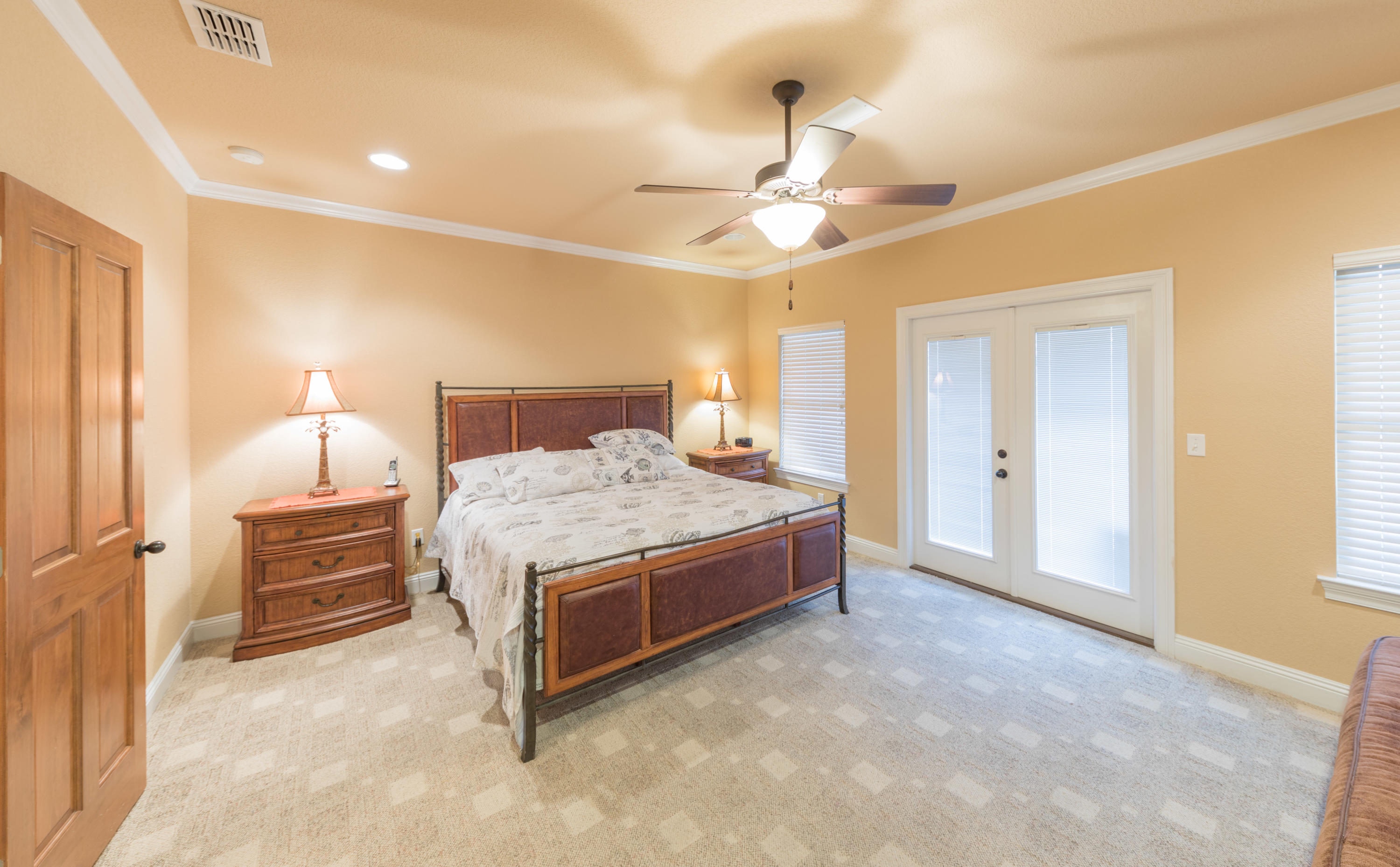 4554 Biscayne Way Destin, FL 32541 - Photo 12 of 24 a spacious bedroom with a bed and a chandelier
