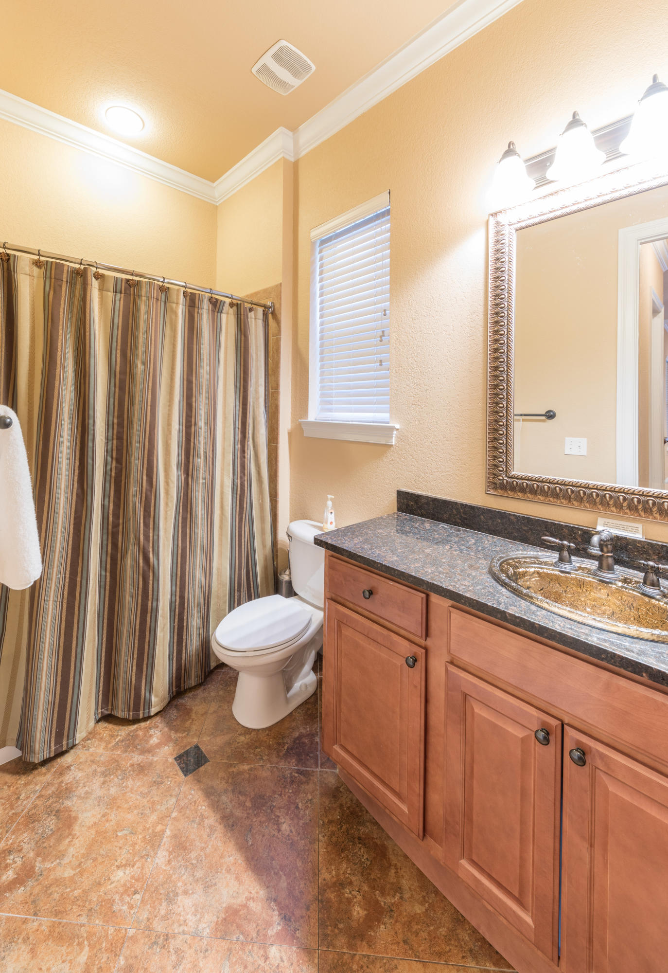 4554 Biscayne Way Destin, FL 32541 - Photo 16 of 24 a bathroom with a toilet a sink and a mirror