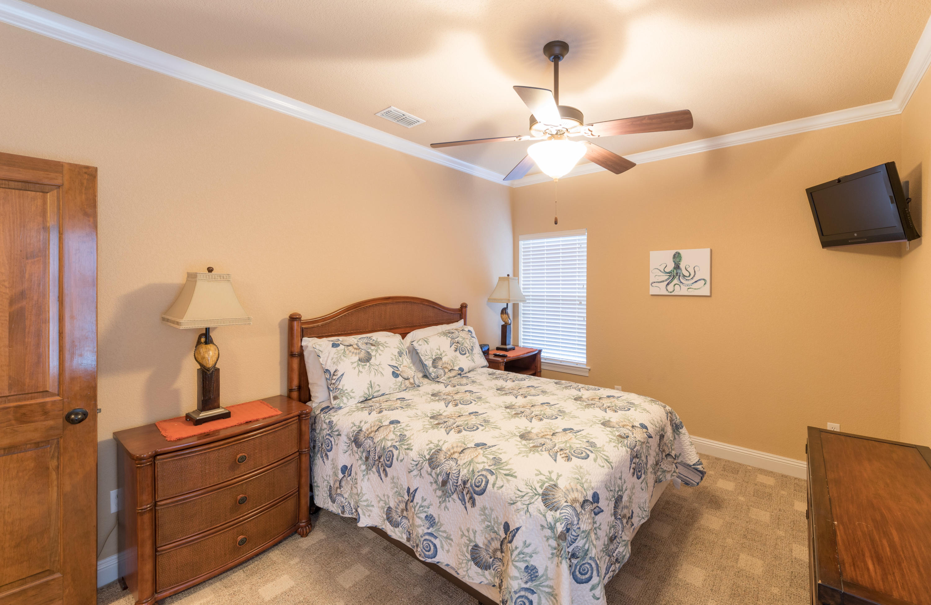 4554 Biscayne Way Destin, FL 32541 - Photo 17 of 24 a bedroom with a bed and ceiling fan