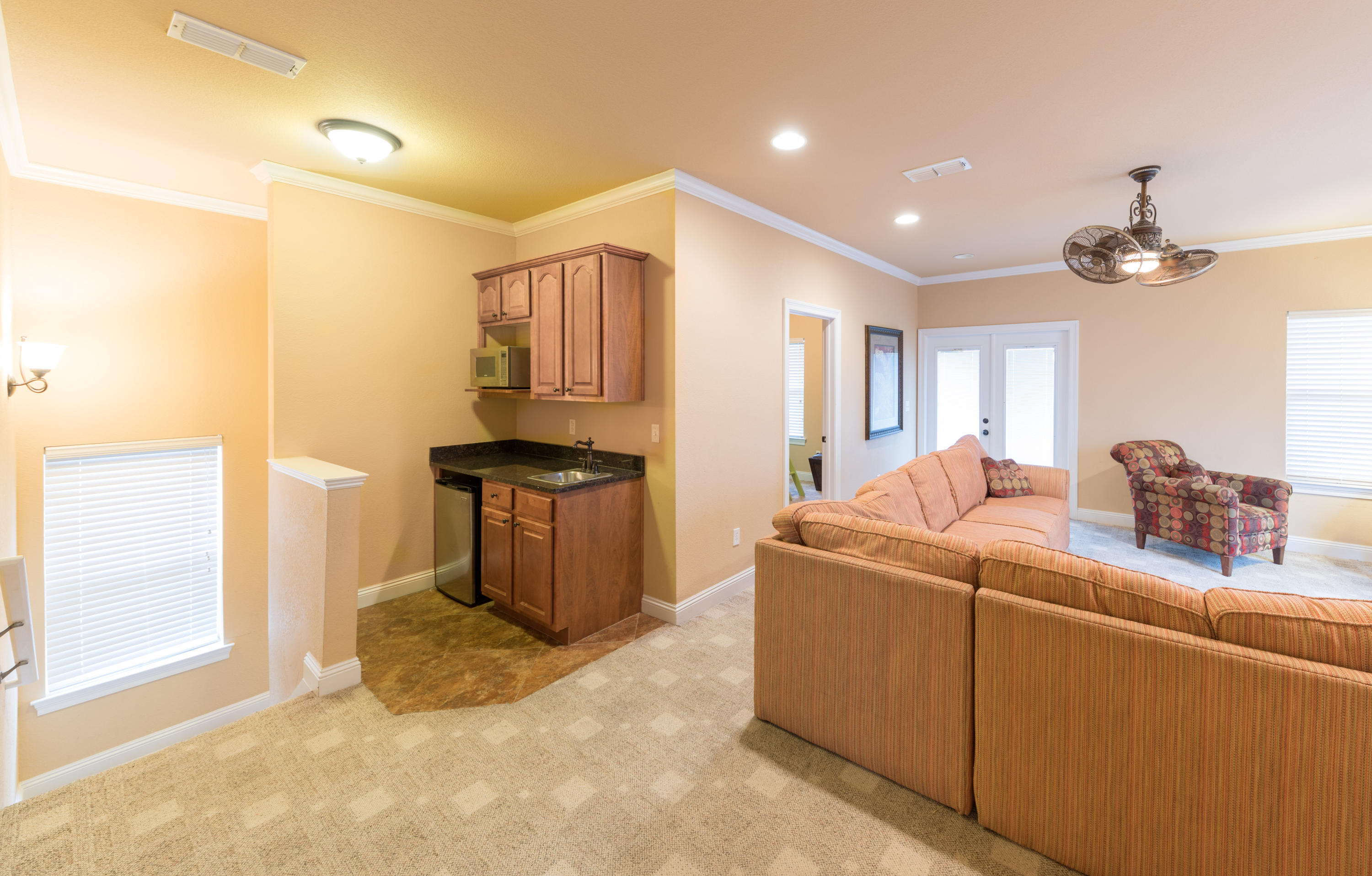 4554 Biscayne Way Destin, FL 32541 - Photo 20 of 24 a living room with furniture a window and kitchen view