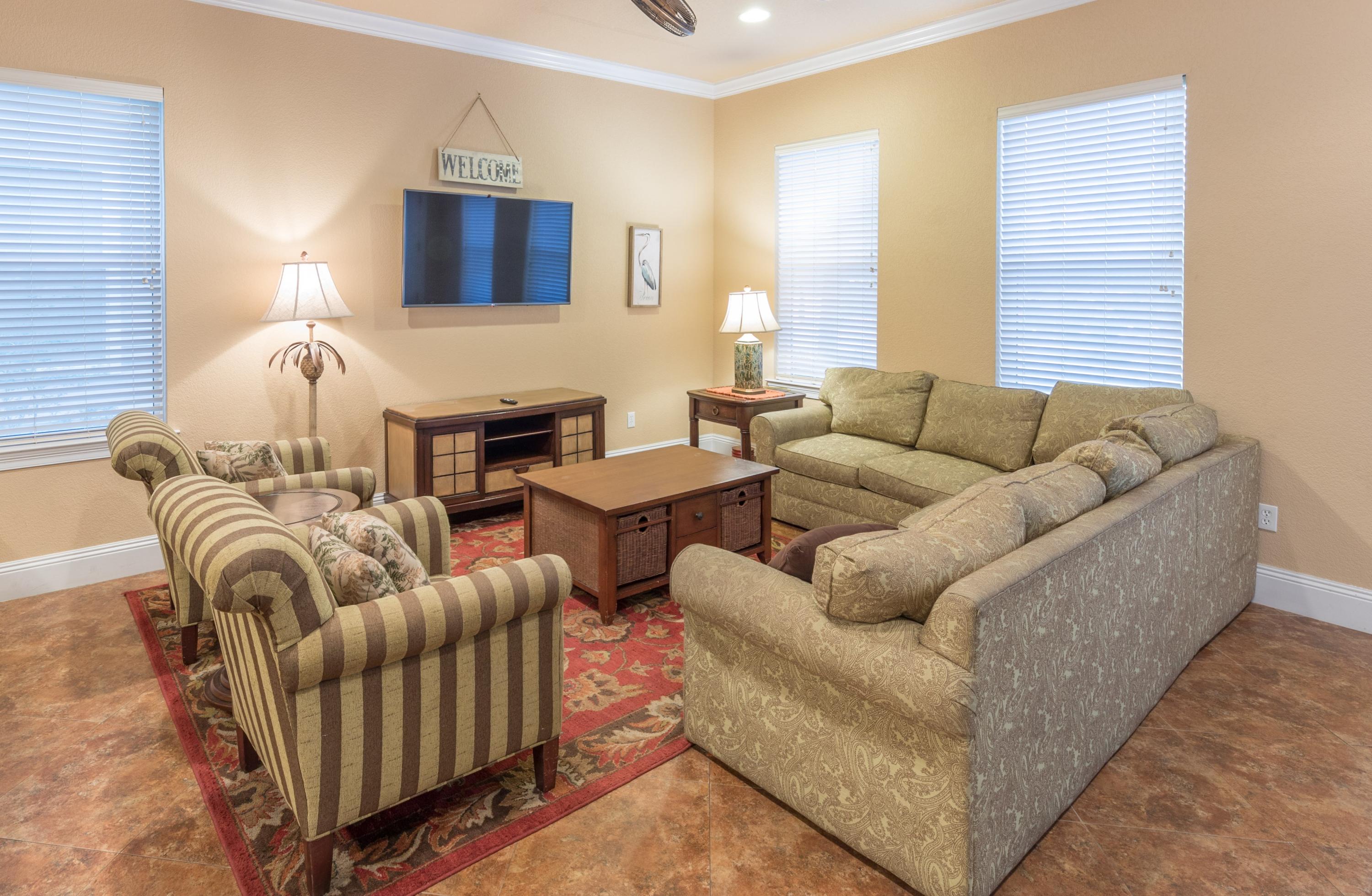 4554 Biscayne Way Destin, FL 32541 - Photo 8 of 24 a living room with furniture and a flat screen tv