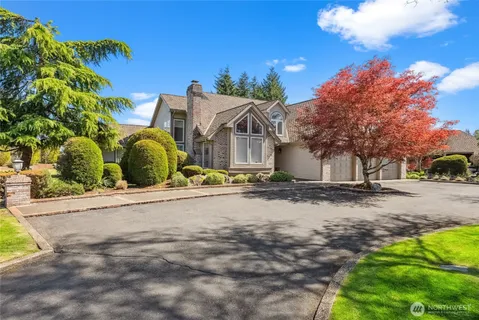 a view of a house with wooden fence
