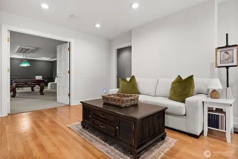 a room with pool table gym equipment and a chandelier