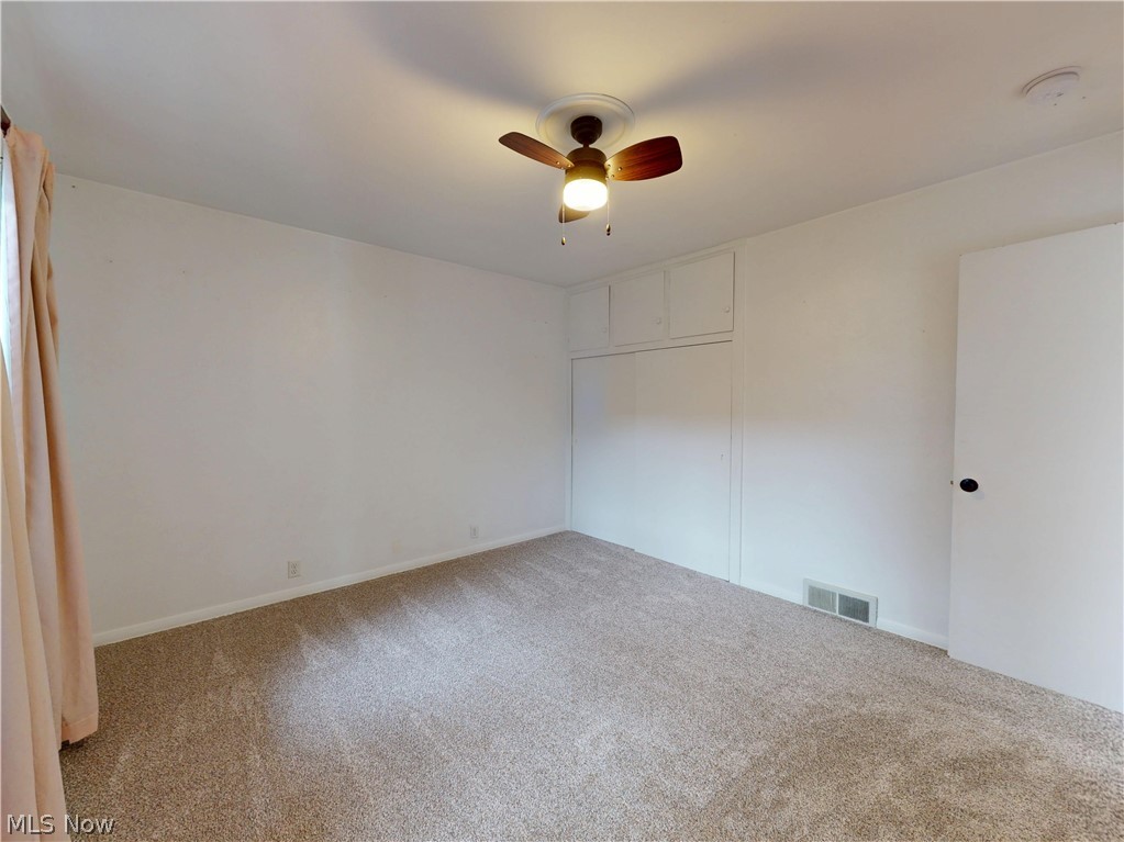 162 South Leavitt Road Amherst, OH 44001 - Photo 28 of 41 Unfurnished bedroom with a closet, carpet, and ceiling fan