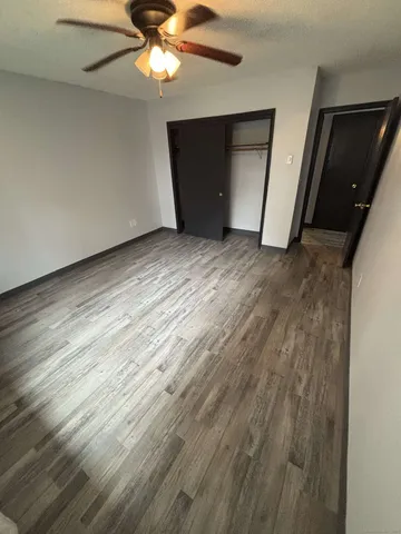 a view of a livingroom with an empty space and a ceiling fan