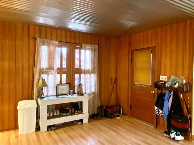 a view of an empty room with a fireplace and windows