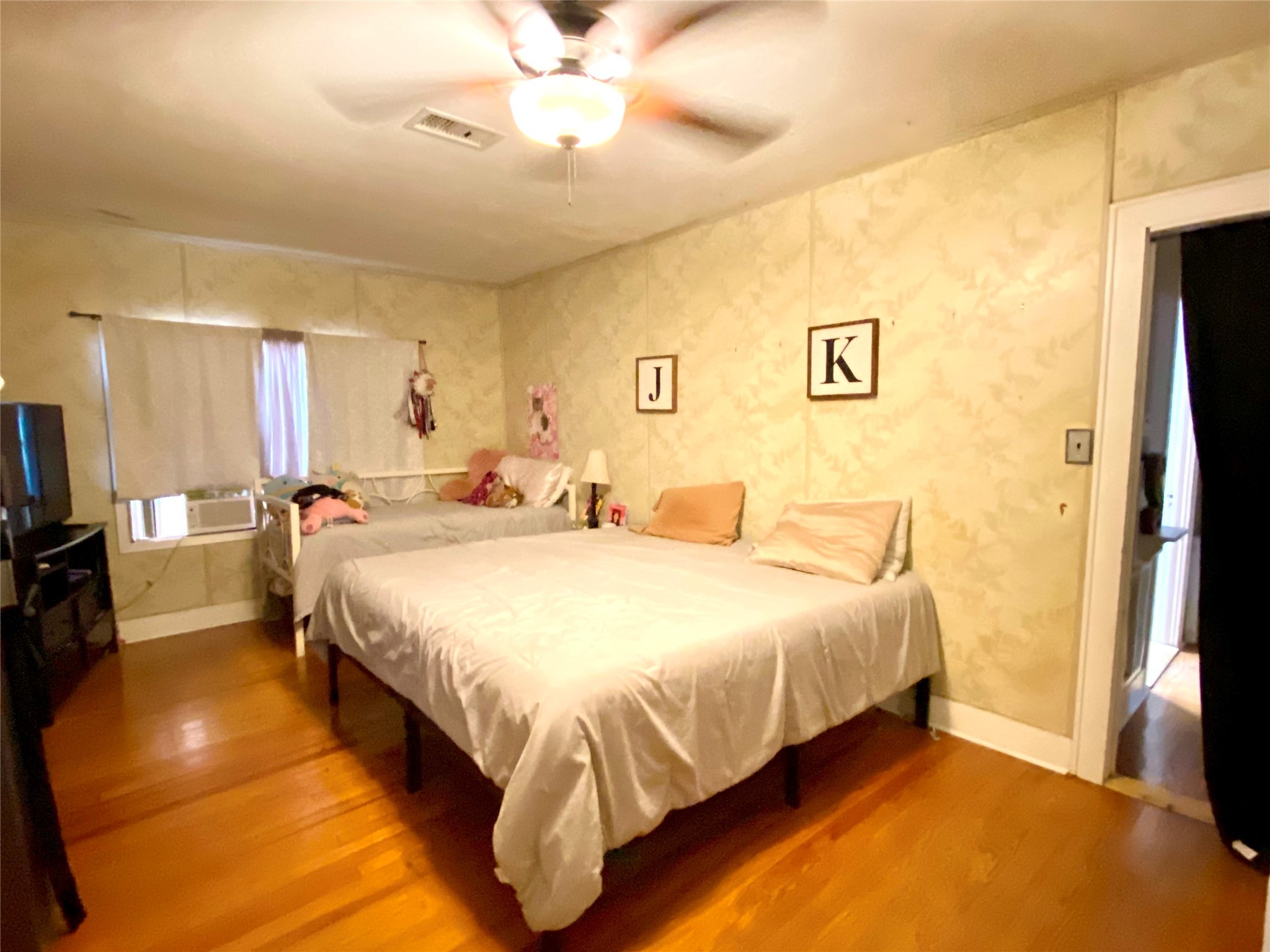 6814 Church Street Wallis, TX 77485 - Photo 17 of 29 a spacious bedroom with a bed and a chandelier