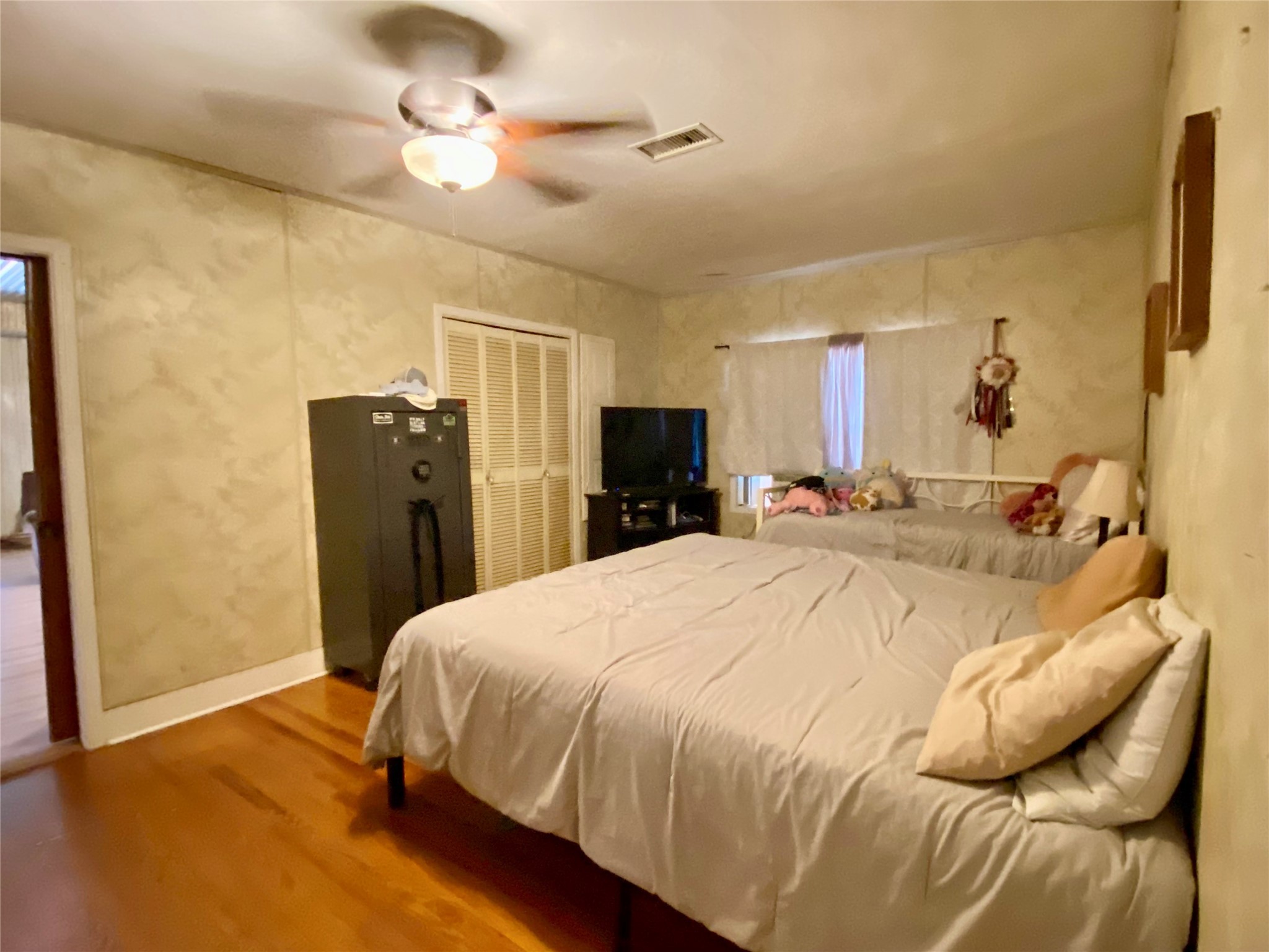 6814 Church Street Wallis, TX 77485 - Photo 18 of 29 a bedroom with a bed and a chandelier