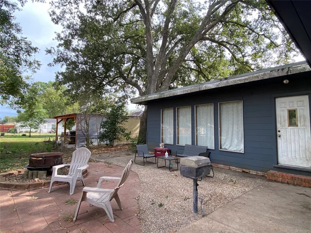 a view of a backyard with furniture and a fire pit