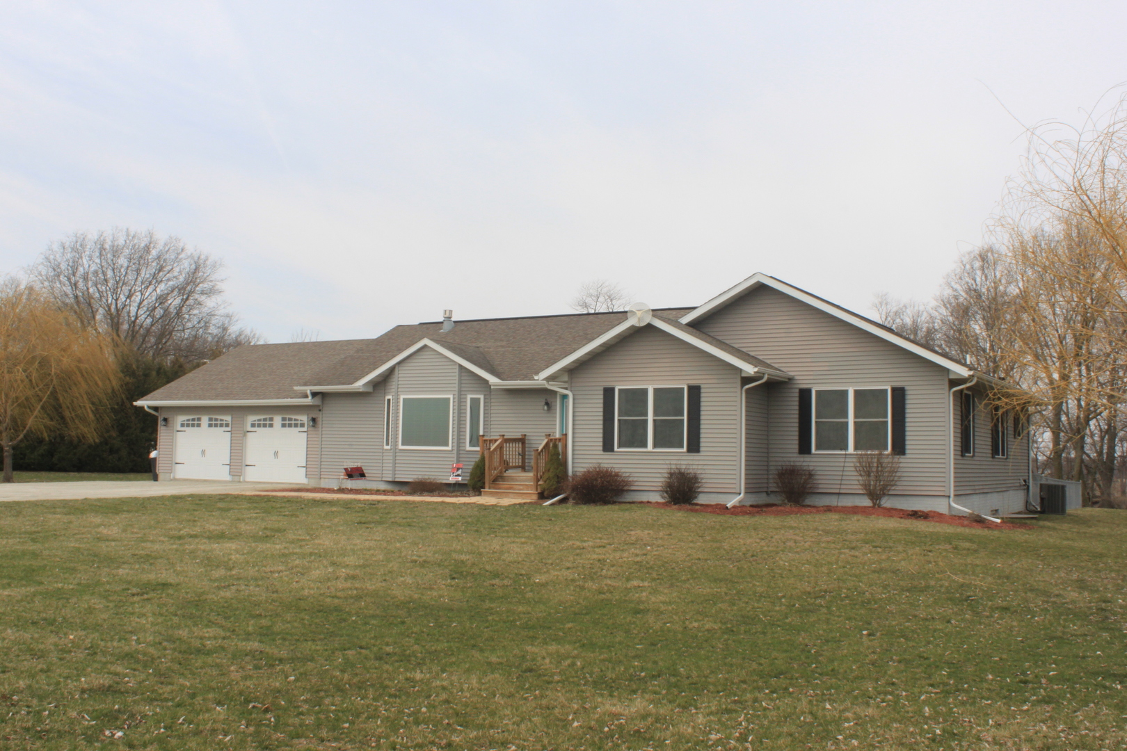 a front view of house with yard and green space