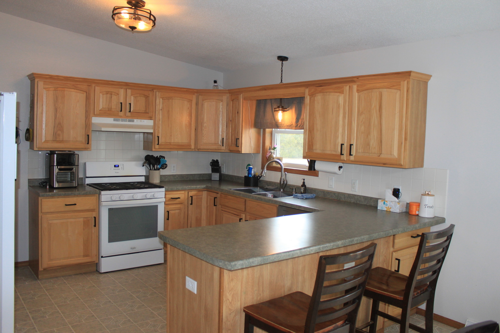 22862 Prophet Road Rock Falls, IL 61071 - Photo 3 of 24 a kitchen with a stove a sink and a refrigerator