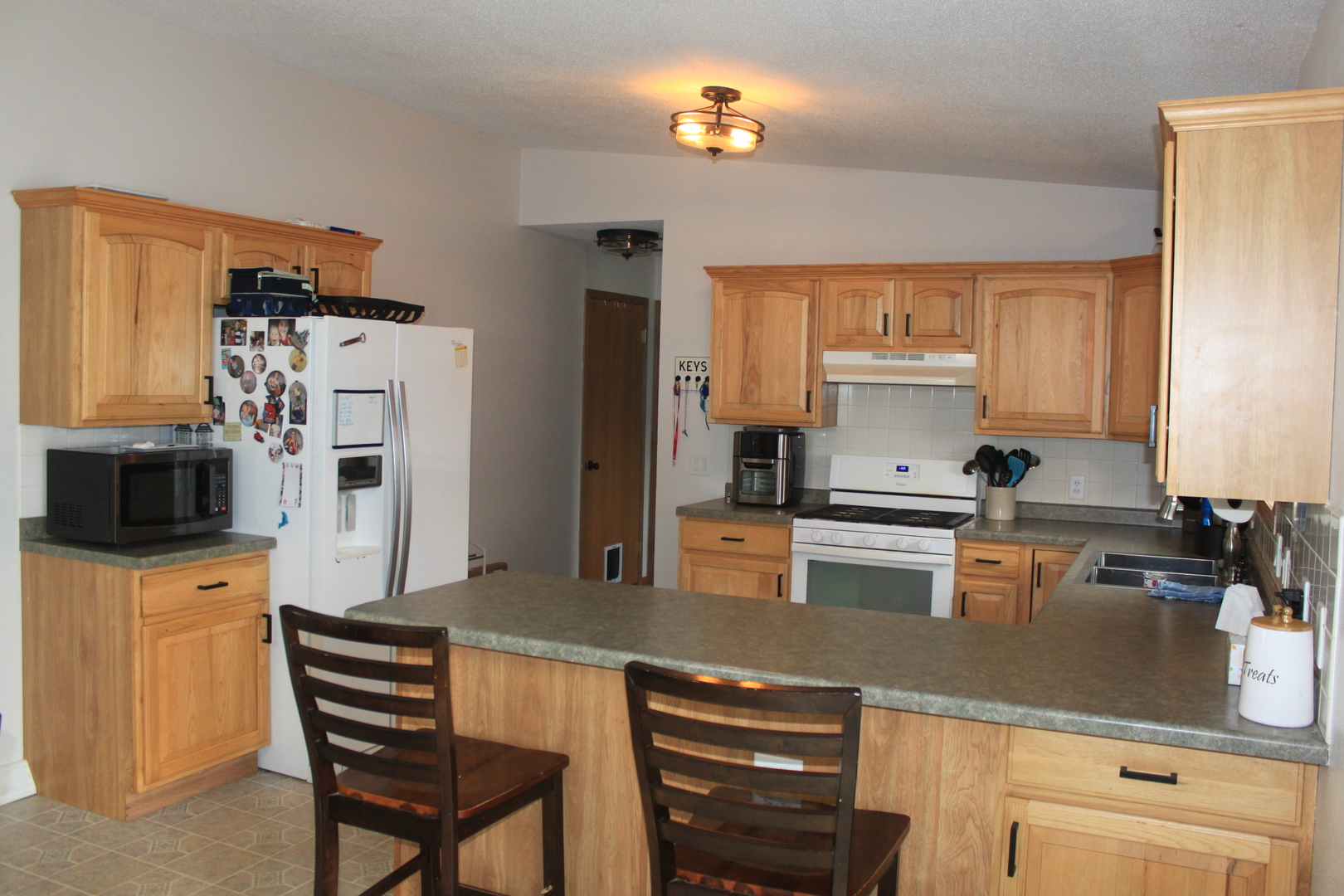 22862 Prophet Road Rock Falls, IL 61071 - Photo 4 of 24 a kitchen with stainless steel appliances a refrigerator a stove a sink dishwasher and white cabinets with wooden floor