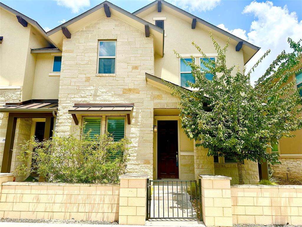6814 East Riverside Drive, Unit 26 Austin, TX 78741 - Photo 1 of 21 A striking exterior featuring a blend of stone and stucco finishes with an inviting gated entrance.