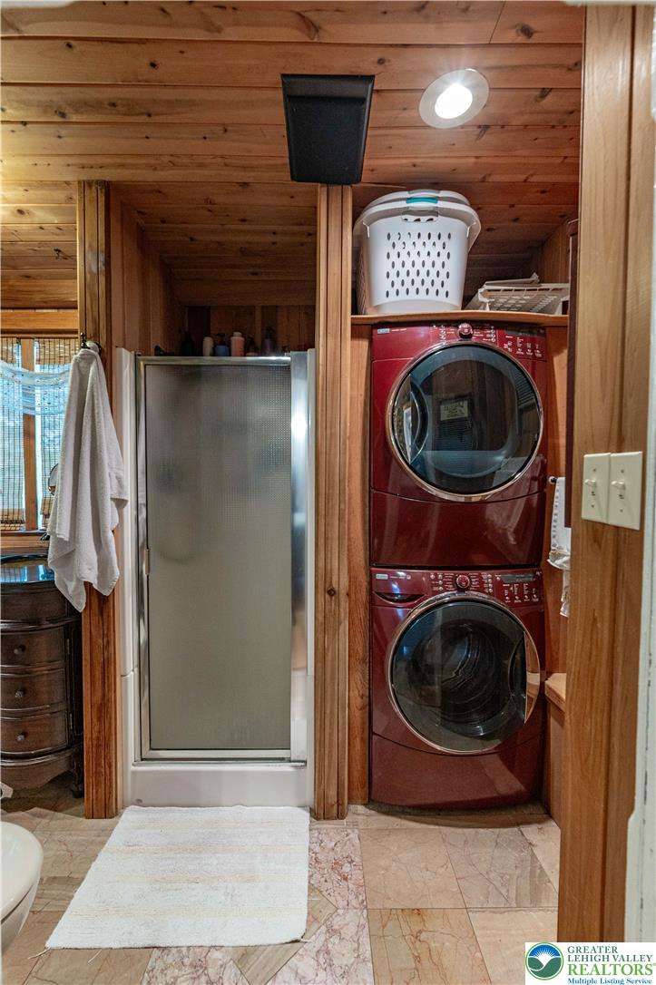 2485 Hieter Road Quakertown, PA 18951 - Photo 30 of 97 A clever arrangement of shower and laundry facilities, encased in warm wooden paneling, creates a versatile space.