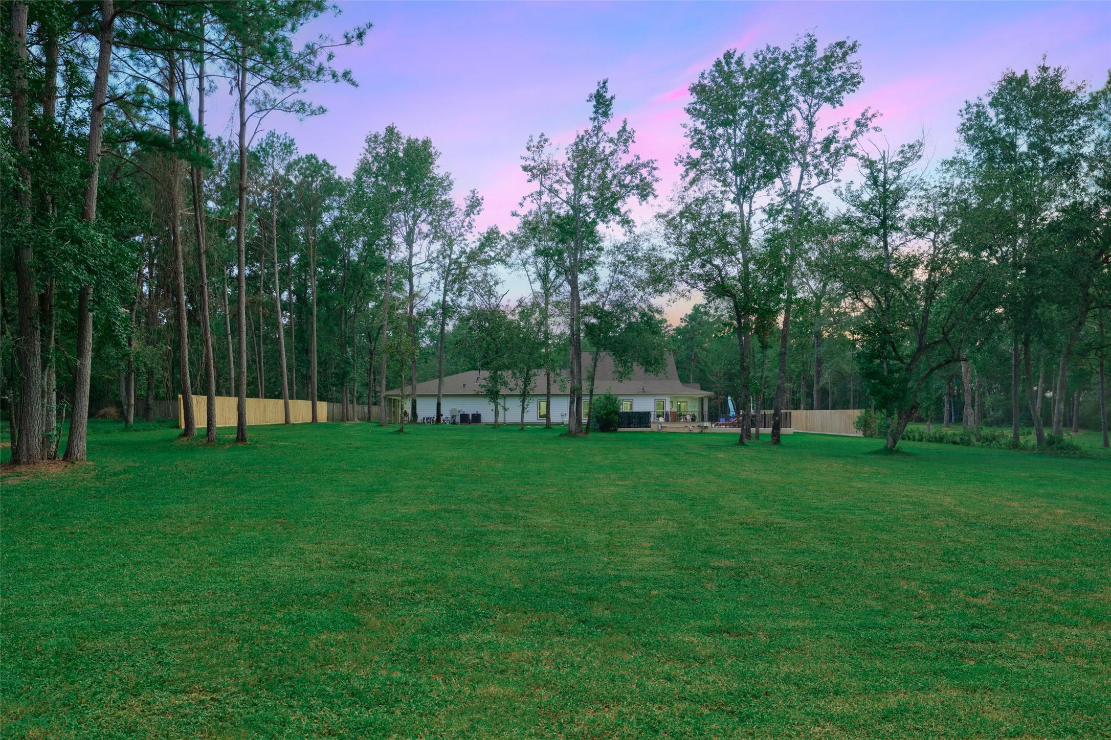 2218 Honea Egypt Road Magnolia, TX 77354 - Photo 18 of 50 Serene, spacious backyard oasis surrounded by lush greenery, perfect for relaxation and outdoor entertainment.