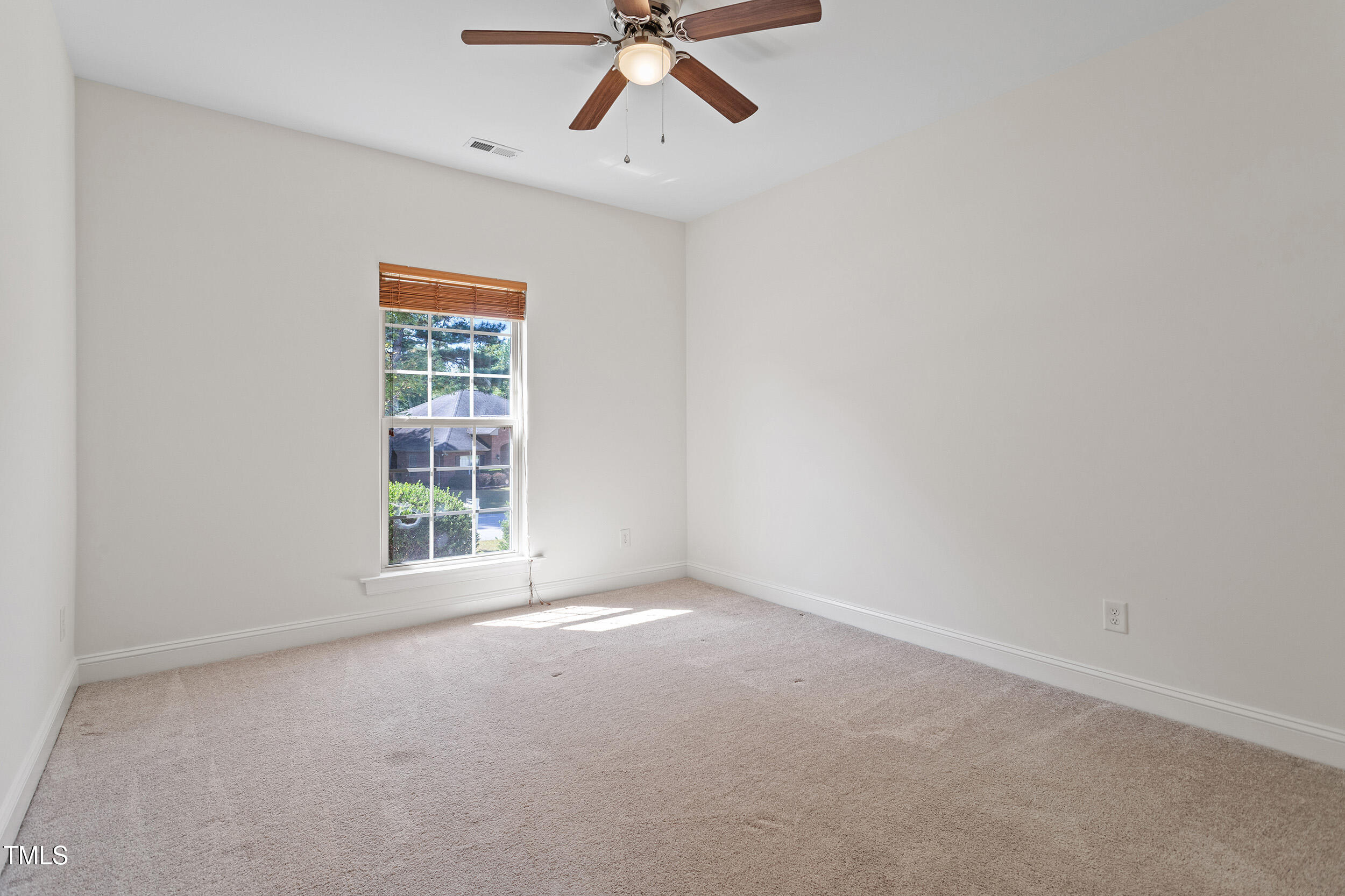 46 Spring Haven Lane Willow Spring, NC 27592 - Photo 35 of 50 an empty room with a window and a fan