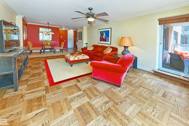 a living room with patio furniture and a flat screen tv
