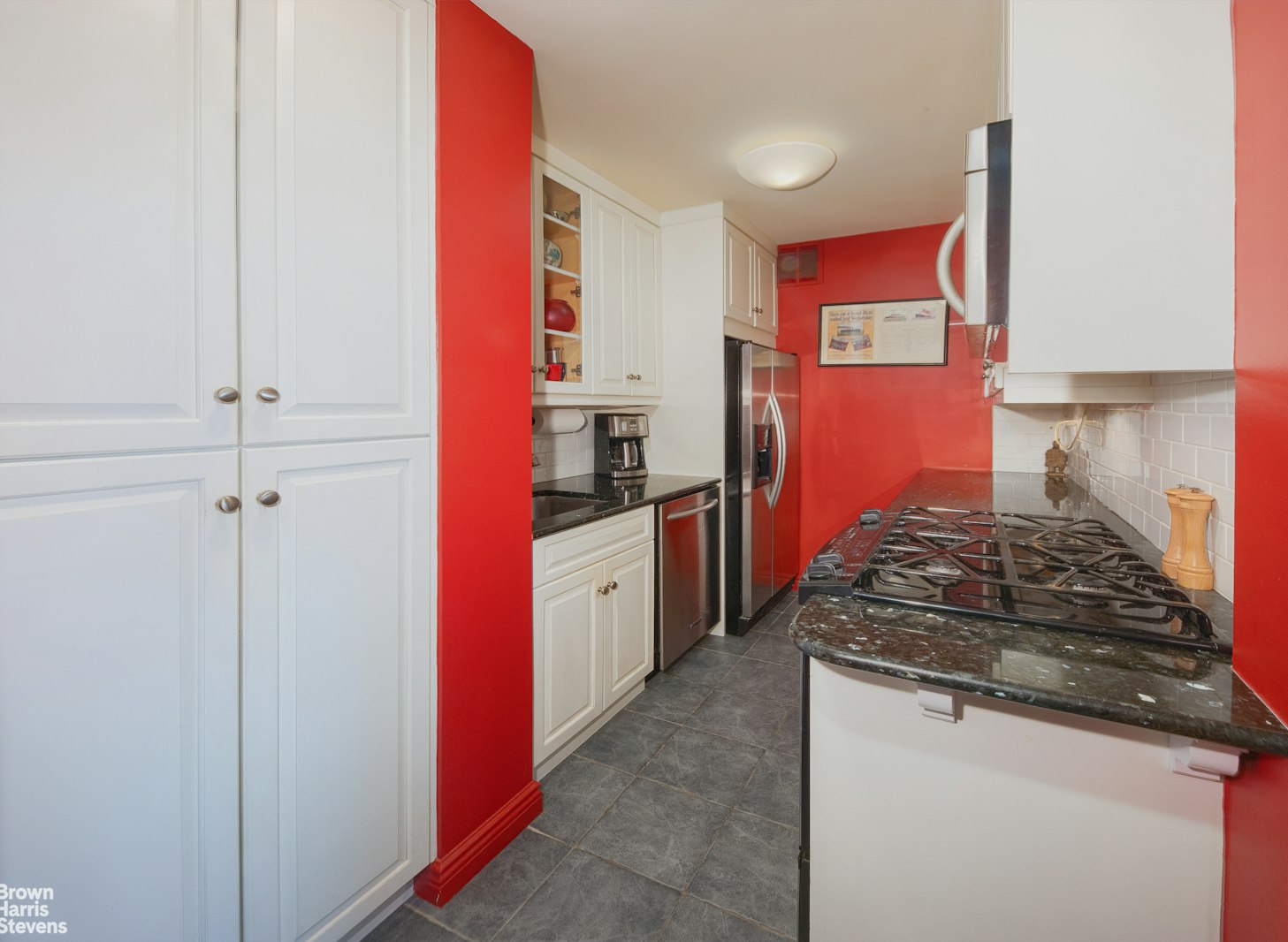 300 East 71st Street, Unit 6M Manhattan, NY 10021 - Photo 4 of 8 a kitchen with stainless steel appliances granite countertop a stove and a refrigerator