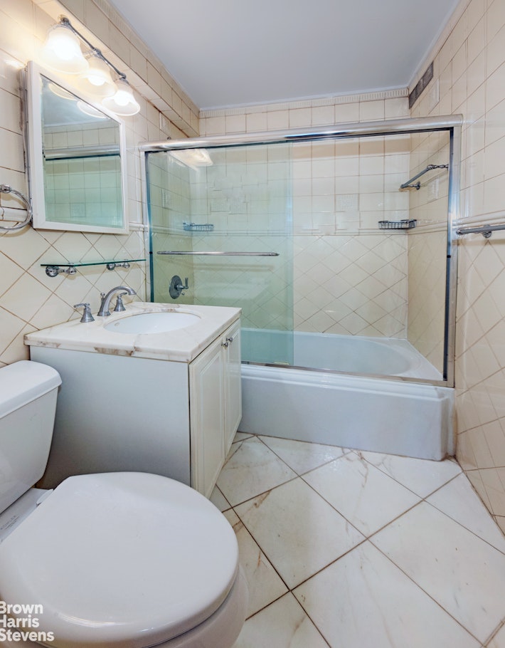 300 East 71st Street, Unit 6M Manhattan, NY 10021 - Photo 6 of 8 a bathroom with a sink and mirror