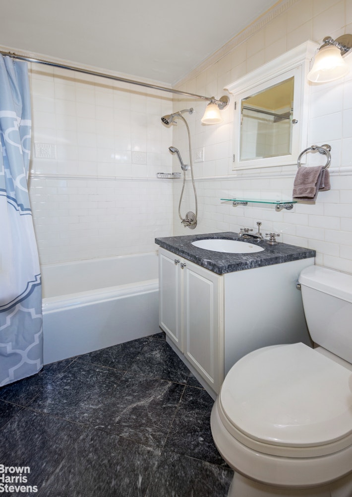300 East 71st Street, Unit 6M Manhattan, NY 10021 - Photo 8 of 8 a bathroom with a sink a toilet and shower