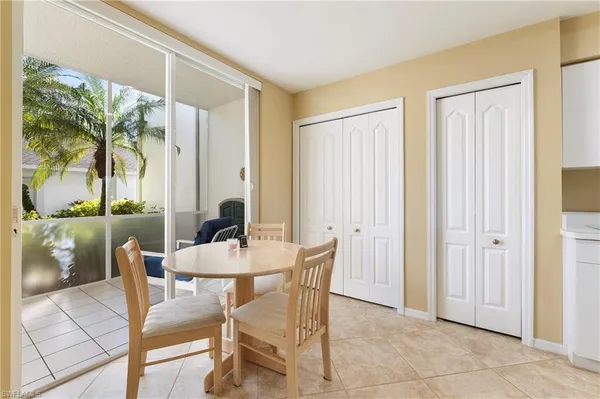 a dining room with furniture and a floor to ceiling window