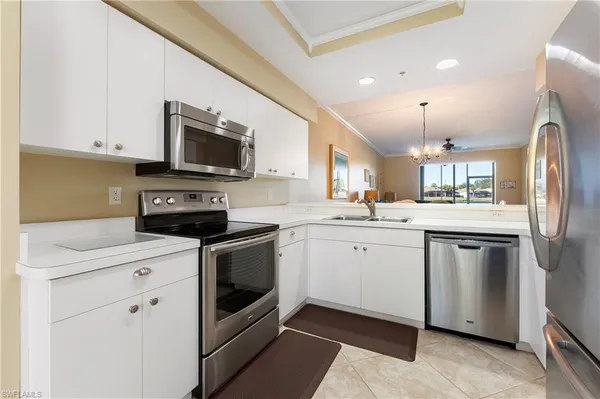 a kitchen with a sink stove and white cabinets
