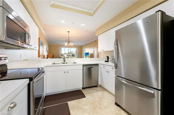 a kitchen with a refrigerator sink and microwave