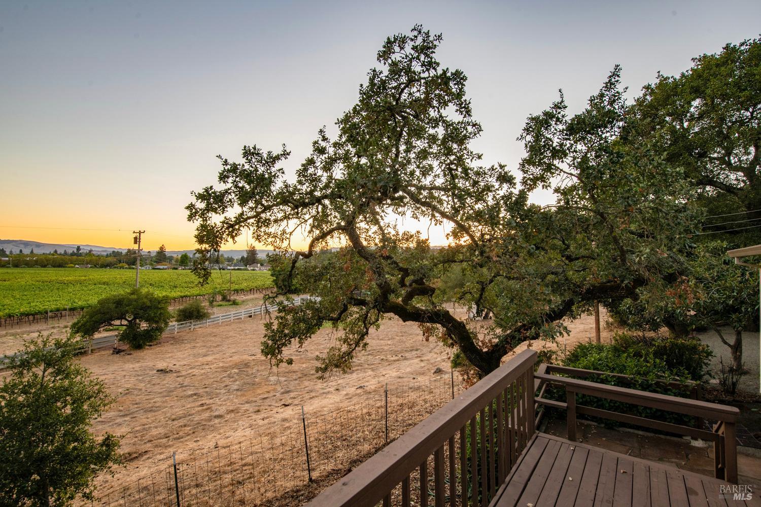 a view of a wooden deck with lake view