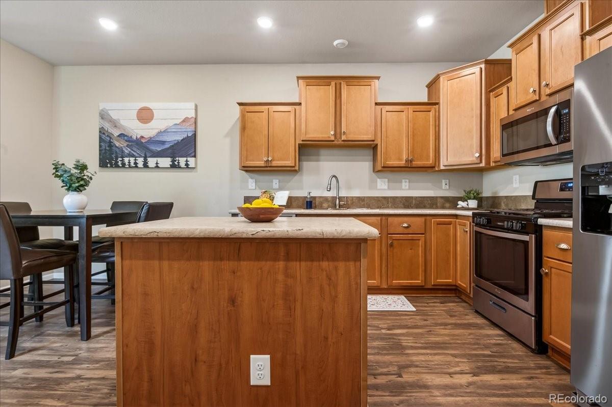 53 Brook Trout Loop Gypsum, CO 81637 - Photo 9 of 38 a kitchen with stainless steel appliances a stove a sink a microwave and cabinets