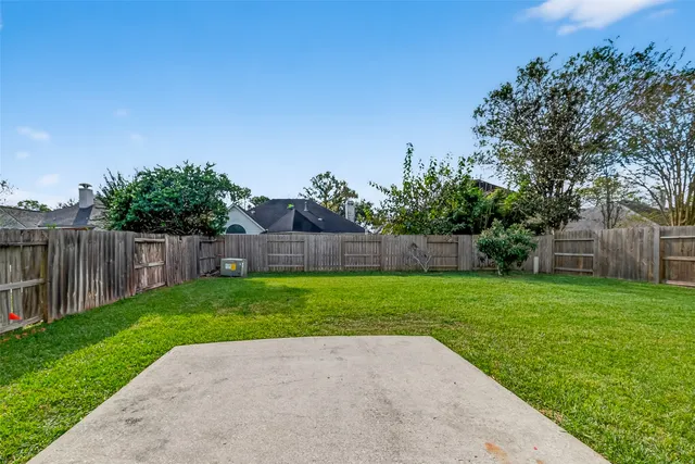 a view of a yard with wooden fence