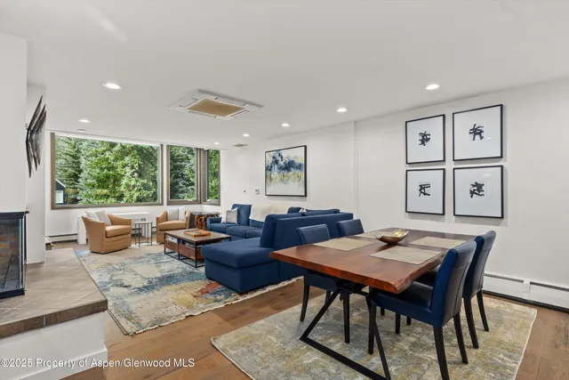 a living room with furniture and large windows