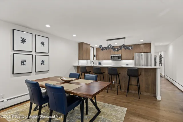 a view of a dining room with furniture and wooden floor
