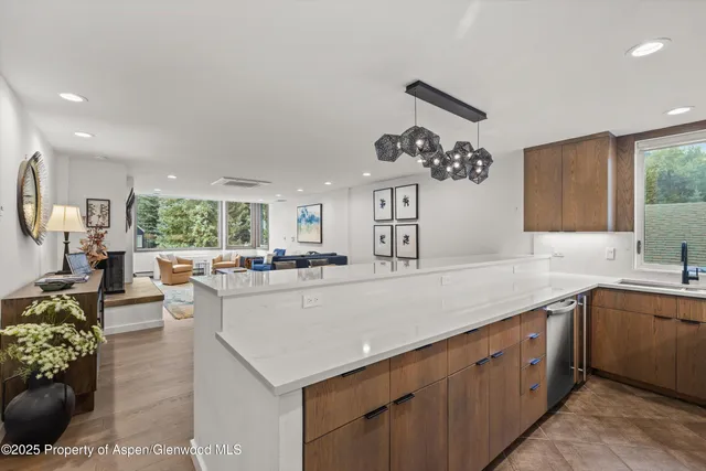 a large white kitchen with a large window