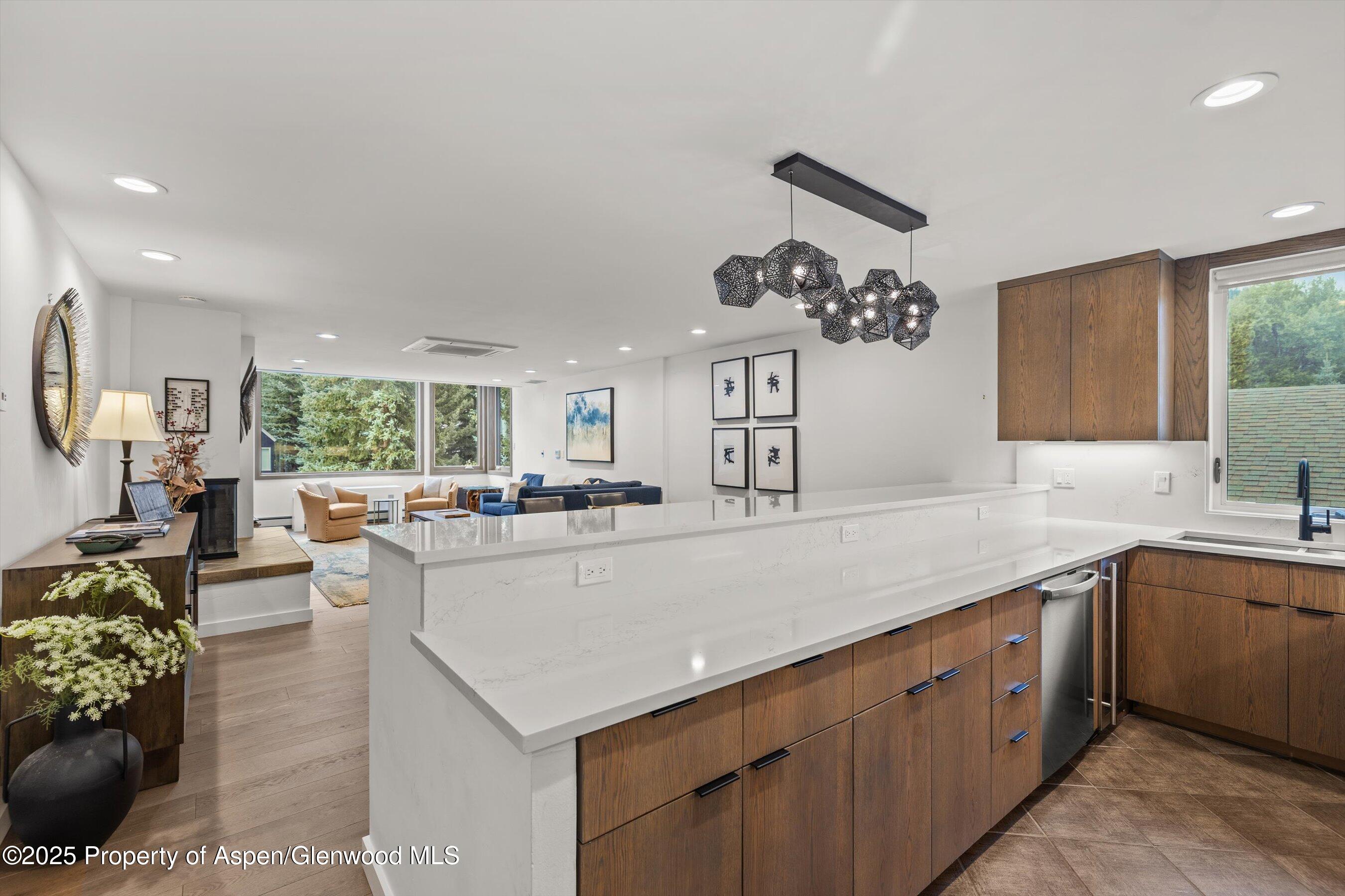 926 Waters Avenue, Unit 301 Aspen, CO 81611 - Photo 6 of 16 a large white kitchen with a large window
