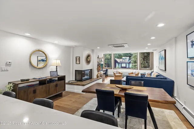 a living room with fireplace furniture and a large window