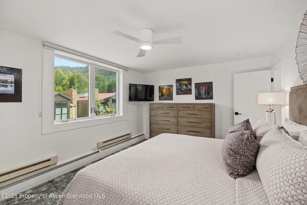a bedroom with a large bed and a window