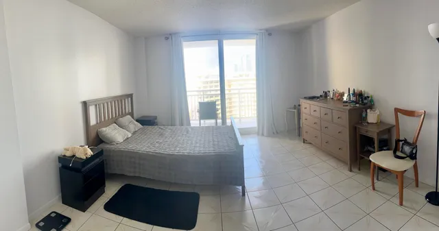 a bed room with a bed and a chair