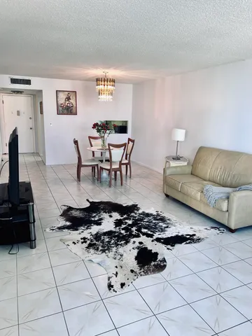 a kitchen with a sink a stove a table and chairs