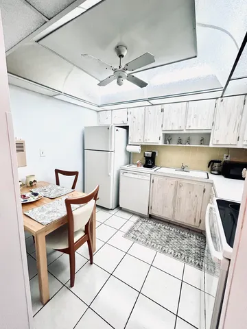 a bathroom with a granite countertop sink a toilet and a mirror