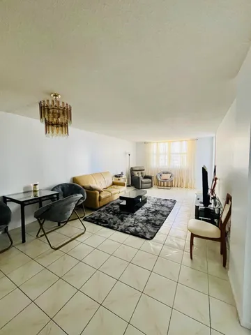a living room with furniture and a piano