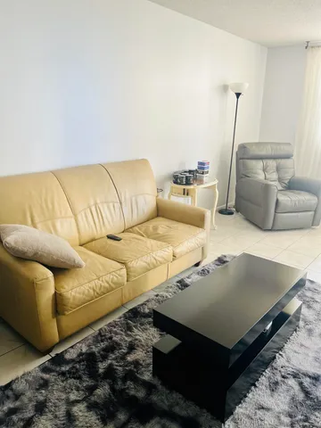 a living room with furniture and a rug