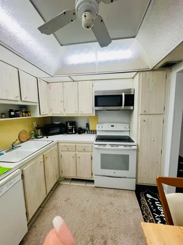 a kitchen with a stove a sink and a refrigerator